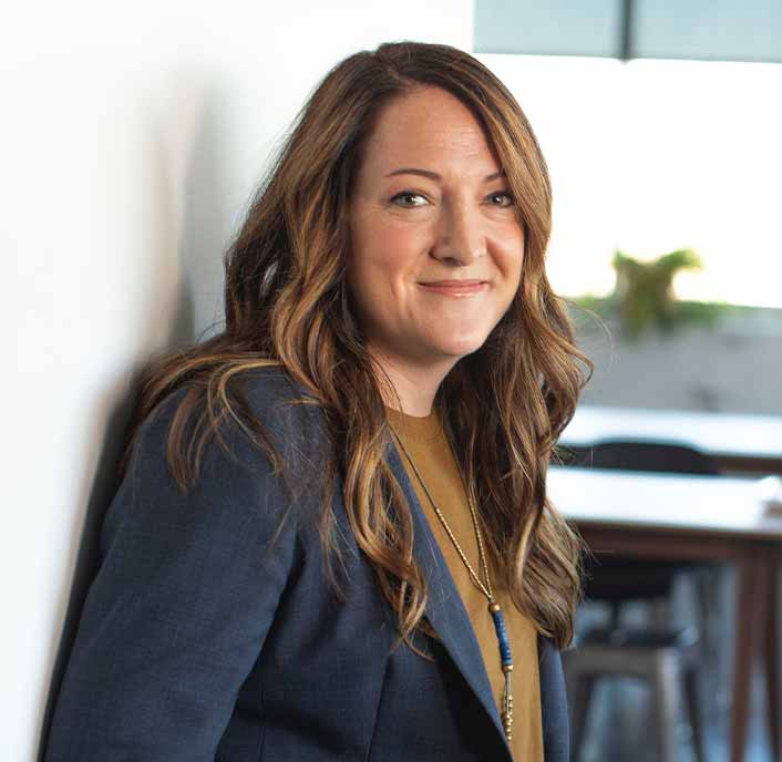 Woman Standing Against Wall Smiling