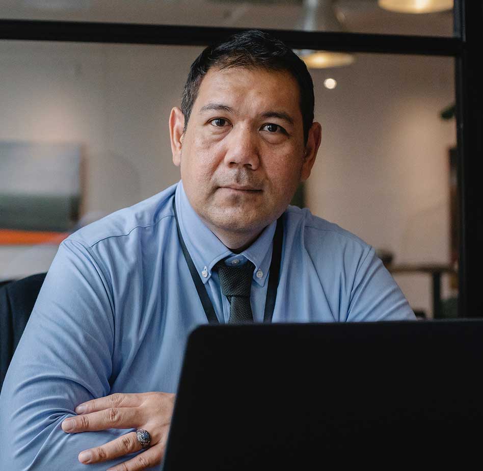 Man Working behind Laptop